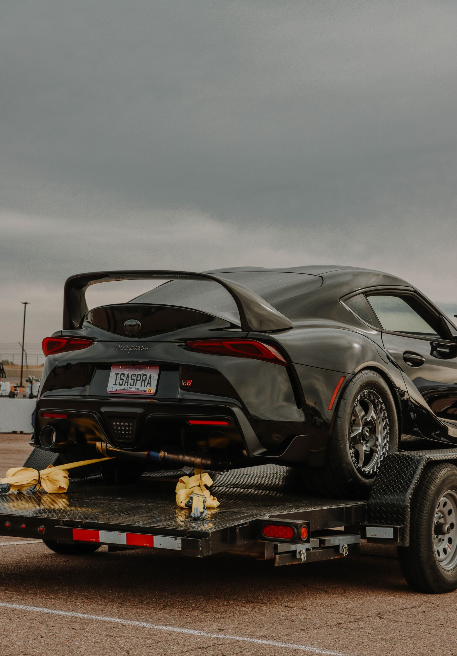 A sports car strapped to a trailer