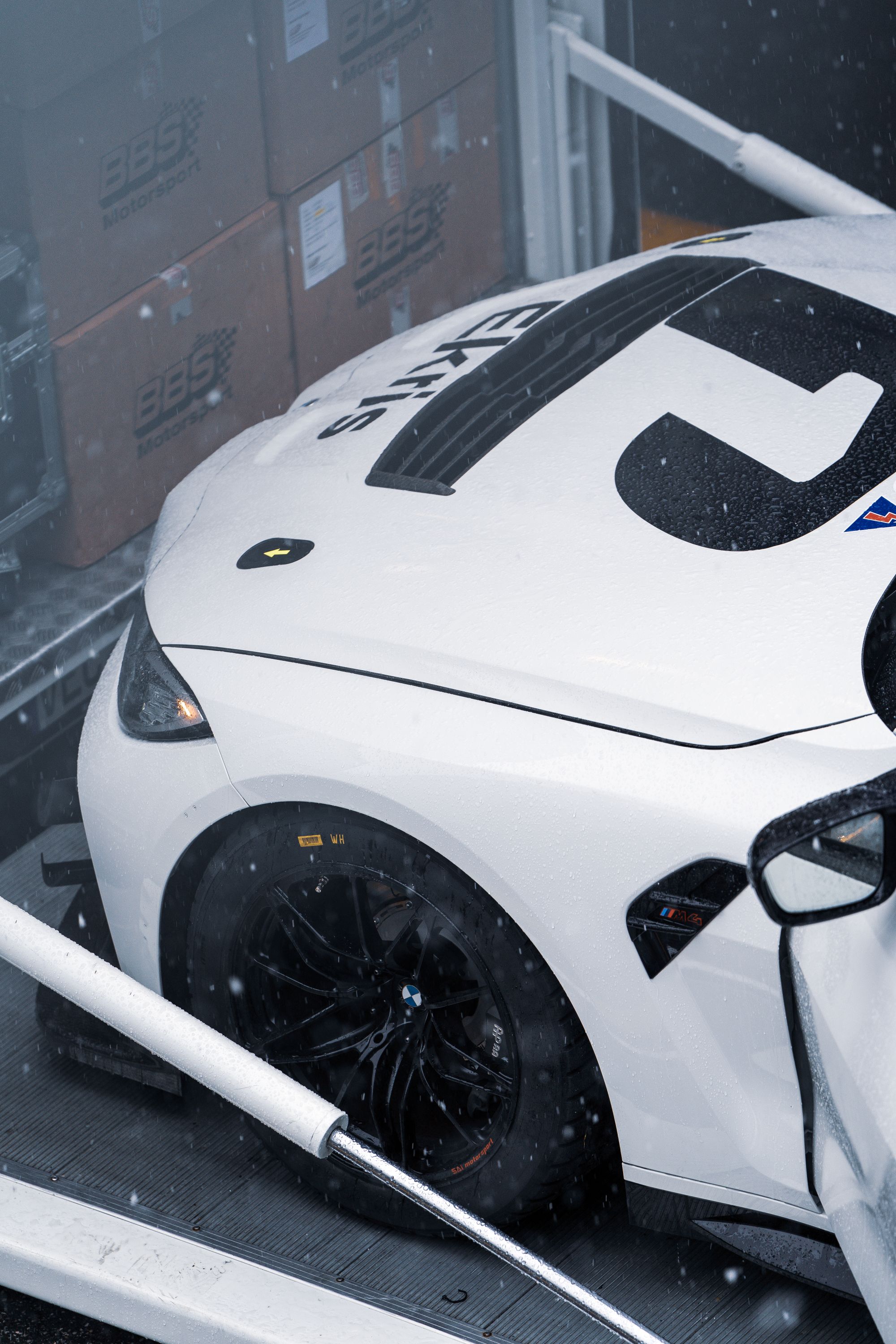 A race car secured inside a covered transporter