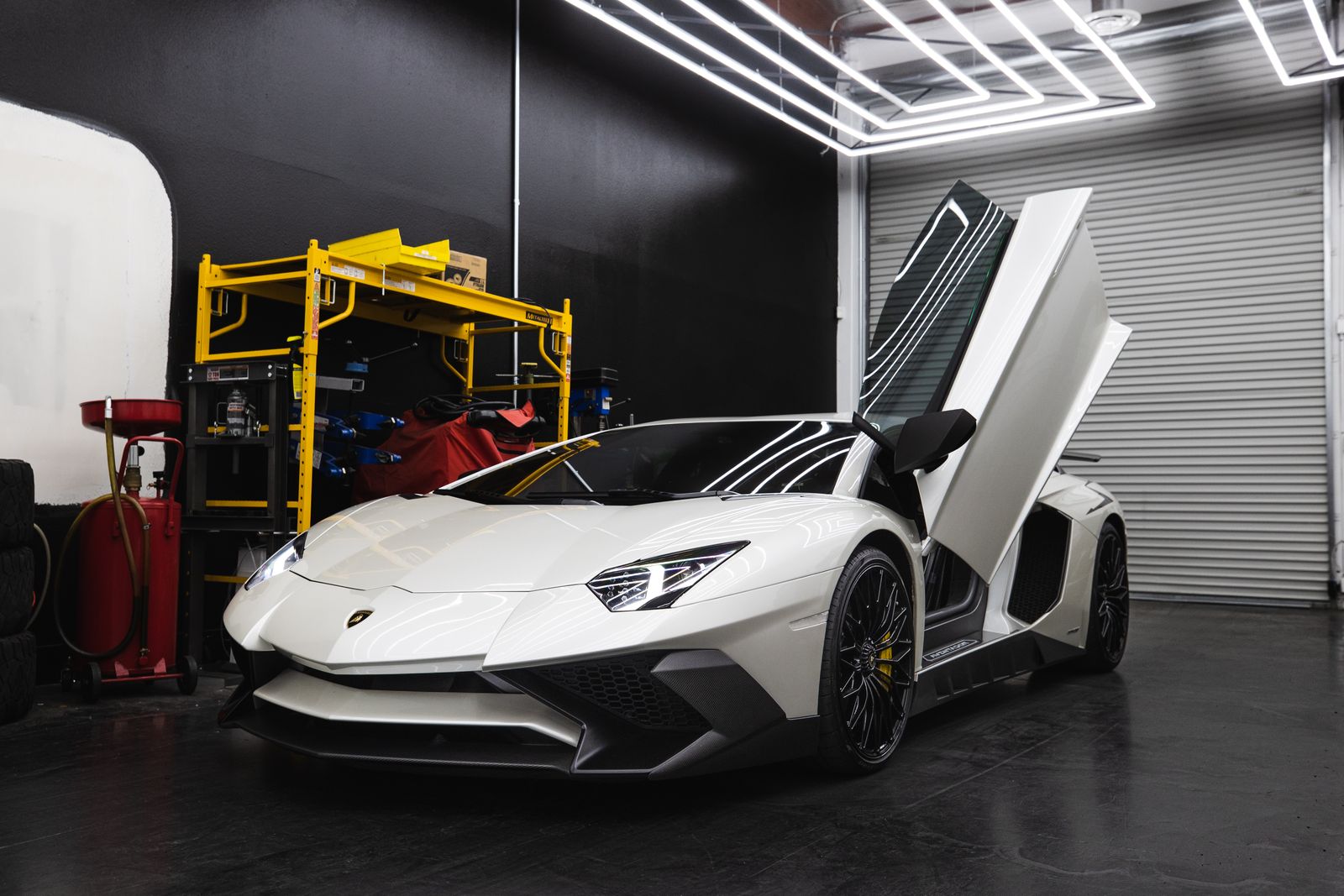 A white supercar in a workshop